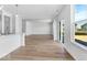 Open-concept living space with light wood floors and a sliding glass door to the outdoors at 385 N Post Oak Dr, Mooresville, IN 46158