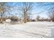 Large backyard, partially covered in snow, with play equipment at 3909 S Lasalle St, Indianapolis, IN 46237
