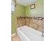 Bathroom with a bathtub and updated tile at 3909 S Lasalle St, Indianapolis, IN 46237