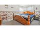 Bedroom with wood framed bed, floral wallpaper, and a red accent chair at 3909 S Lasalle St, Indianapolis, IN 46237