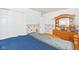 Bedroom with a wooden dresser and double bed, floral wallpaper accents at 3909 S Lasalle St, Indianapolis, IN 46237