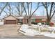 Brick ranch house with attached garage, driveway, and mature trees at 3909 S Lasalle St, Indianapolis, IN 46237