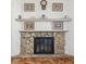 Stone fireplace with a black metal screen and a wood mantel at 3909 S Lasalle St, Indianapolis, IN 46237