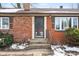 Front entrance with brick steps and storm door at 3909 S Lasalle St, Indianapolis, IN 46237