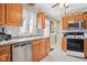 Modern kitchen with stainless steel appliances and wood cabinetry at 3909 S Lasalle St, Indianapolis, IN 46237