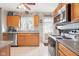 Eat-in kitchen, complete with stainless steel appliances and wood cabinets at 3909 S Lasalle St, Indianapolis, IN 46237