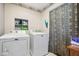 Laundry room with washer, dryer, and built-in shelving at 3909 S Lasalle St, Indianapolis, IN 46237