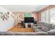 Living room with gray sectional sofa and large windows at 3909 S Lasalle St, Indianapolis, IN 46237