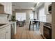 Modern kitchen with white cabinets, stainless steel appliances, and a breakfast bar at 4450 Evanston Ave, Indianapolis, IN 46205