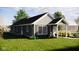 Green house exterior with covered porch and landscaping at 4521 Norwaldo Ave, Indianapolis, IN 46205