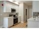 White cabinets, stainless steel appliances, and light wood floors at 4521 Norwaldo Ave, Indianapolis, IN 46205