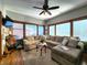 Relaxing living room with a sectional sofa, hardwood floors, and large windows at 5419 E Shae Lake Dr, Mooresville, IN 46158