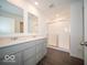 Bathroom with dual sink vanity, framed mirrors, and glass enclosed shower at 5592 Cattail Branch Ln, Clayton, IN 46118