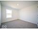 Bright room with carpet, white walls, and large window at 5592 Cattail Branch Ln, Clayton, IN 46118