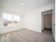 Bright bedroom with neutral carpet and large window with a neighborhood view at 5592 Cattail Branch Ln, Clayton, IN 46118