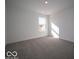 Bright bedroom featuring a large window and neutral carpeting at 5592 Cattail Branch Ln, Clayton, IN 46118