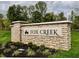 Stone entrance sign for Fox Creek community at 5592 Cattail Branch Ln, Clayton, IN 46118