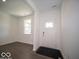 Entryway featuring modern vinyl floors, white walls, and a window with a view of the front yard at 5592 Cattail Branch Ln, Clayton, IN 46118