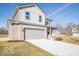 Charming two-story home featuring a two-car garage, gray brick, gray siding, and a well-manicured lawn at 5592 Cattail Branch Ln, Clayton, IN 46118