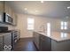Close-up of kitchen island, stainless dishwasher and double oven at 5592 Cattail Branch Ln, Clayton, IN 46118
