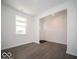 Living Room featuring modern vinyl floors, white walls, and a window with a view of the front yard at 5592 Cattail Branch Ln, Clayton, IN 46118