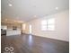 Spacious living room featuring vinyl flooring, recessed lighting and an open floor plan to the kitchen at 5592 Cattail Branch Ln, Clayton, IN 46118