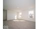 Bright living room features neutral carpeting and view of the outdoors at 5592 Cattail Branch Ln, Clayton, IN 46118