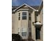 Tan two story home with bay windows and dark green door at 706 Shagbark Ct, Plainfield, IN 46168
