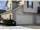 Attached two-car garage with light beige doors and brick facade at 706 Shagbark Ct, Plainfield, IN 46168