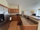 Modern kitchen with stainless steel appliances and wood cabinets at 706 Shagbark Ct, Plainfield, IN 46168