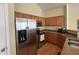 Modern kitchen with stainless steel appliances and wood cabinets at 706 Shagbark Ct, Plainfield, IN 46168