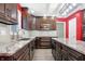 Modern kitchen with dark wood cabinets and granite countertops at 7089 Hidden Valley Dr, Plainfield, IN 46168