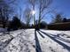 Large backyard with snow and tree shadows at 721 Leisure Ln, Greenwood, IN 46142