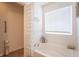 Serene bathroom featuring a soaking tub, neutral decor, and ample natural light at 7730 Belmac Ln, Camby, IN 46113