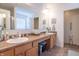 Well-lit bathroom featuring a double vanity, a large mirror and tile flooring at 7730 Belmac Ln, Camby, IN 46113