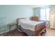 This well-lit bedroom features laminate floors and a large window for natural light at 7730 Belmac Ln, Camby, IN 46113