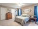 Well-lit bedroom features neutral tones, comfortable bed, and stylish furnishings at 7730 Belmac Ln, Camby, IN 46113