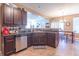 Well-equipped kitchen with stainless steel appliances, tile backsplash, and an open view to the dining area at 7730 Belmac Ln, Camby, IN 46113