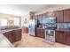 Bright kitchen with stainless steel appliances, tile backsplash, and abundant cabinet space at 7730 Belmac Ln, Camby, IN 46113