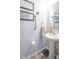 This well-appointed powder room includes a pedestal sink and decorative wall hangings at 7730 Belmac Ln, Camby, IN 46113