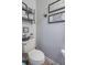 This powder room features decor above the toilet tank and tile flooring at 7730 Belmac Ln, Camby, IN 46113
