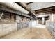 Unfinished basement with exposed brick and concrete floor at 940 W 53Rd St, Indianapolis, IN 46208