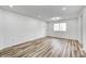 Simple bedroom with LVP flooring and a large window at 940 W 53Rd St, Indianapolis, IN 46208