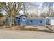 Blue house with attached garage and mature trees at 940 W 53Rd St, Indianapolis, IN 46208