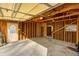 Unfinished garage with concrete floor, shelving, and overhead door at 940 W 53Rd St, Indianapolis, IN 46208
