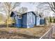Side view of blue house with deck and landscaping at 940 W 53Rd St, Indianapolis, IN 46208