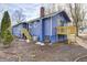 Rear view of blue house with deck and landscaping at 940 W 53Rd St, Indianapolis, IN 46208