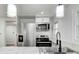 Modern kitchen with stainless steel appliances and white shaker cabinets at 940 W 53Rd St, Indianapolis, IN 46208
