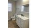 Modern bathroom with white vanity, updated fixtures, and wood-look floors at 9710 E 38Th St, Indianapolis, IN 46235