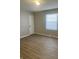 Bright bedroom with wood-look floors and neutral wall paint at 9710 E 38Th St, Indianapolis, IN 46235